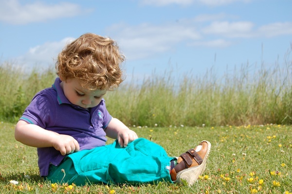 Young boy sitting on grass