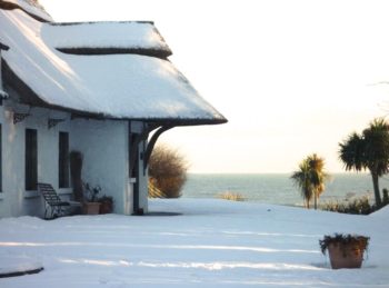 Seasons Greetings from the Cottages Ireland - Thatcher's Rest covered in snow