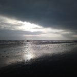 Sun reflects on Bettystown beach with horse riding in background